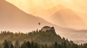 A hot air balloon flying over the mountains.