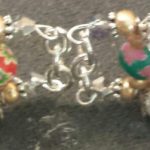 A close up of the bracelet with two different colored beads