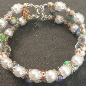 A bracelet with white beads and silver accents.