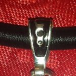 A close up of the metal clasp on a red bag