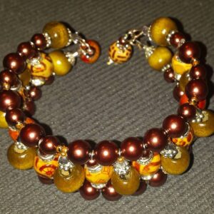 A bracelet with brown and yellow beads on it.