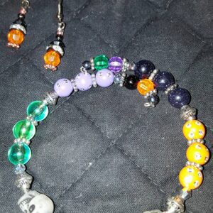 A bracelet and earrings set with various colors of beads.