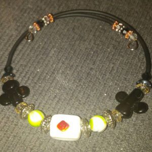 A necklace with beads and an orange square.