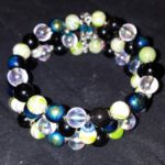 A bracelet with black, blue and green beads.