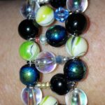 A bracelet with different colored beads on it.