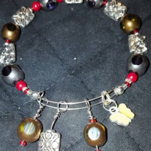 A bracelet with various beads and charms on it.