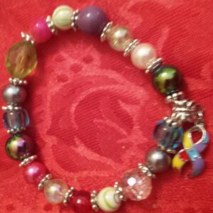 A bracelet with different colored beads and charms.