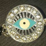 A close up of an evil eye on a chain