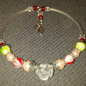 A necklace with beads and a glass heart.