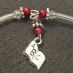 A close up of the bracelet with a charm