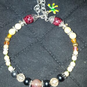 A bracelet with beads and charms on it.