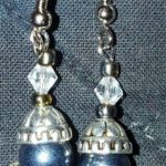 A pair of blue and silver earrings with clear beads.