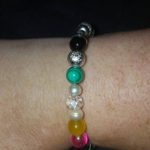 A bracelet with different colored beads on it.