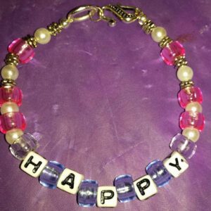 A necklace with the word happy spelled in beads.