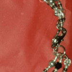 A close up of the chain on a red cloth