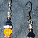 A pair of earrings with beads and metal wires.