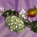 A close up of some jewelry on top of purple fabric