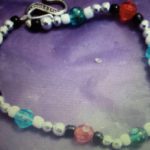 A bracelet with beads and a heart charm.