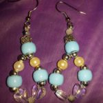 A pair of earrings with blue and yellow beads.