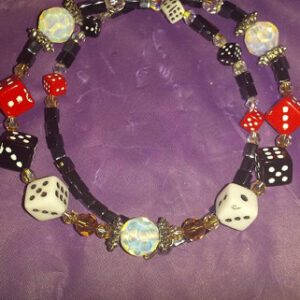 A necklace with dice and other beads on it.