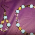 A bracelet and earrings set with blue beads.