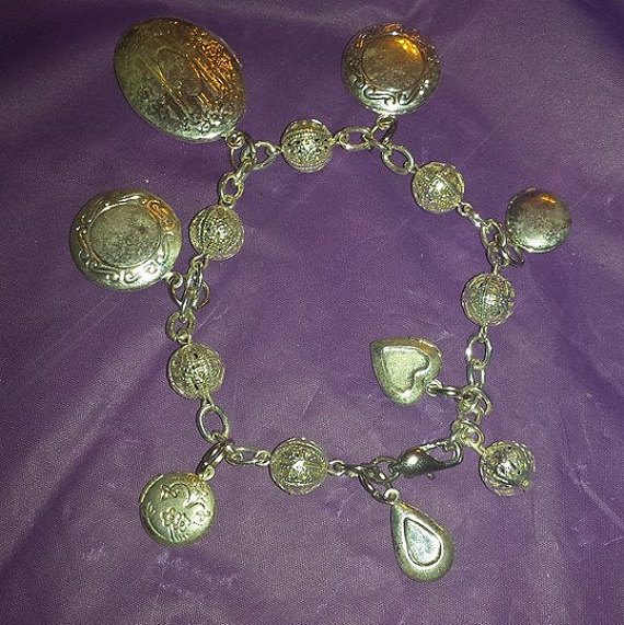 A silver bracelet with many small charms on it.