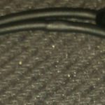 A close up of the end of an apple charger.