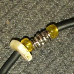 A close up of the wire with some yellow plastic caps