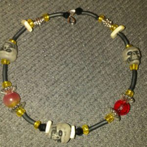 A necklace with skulls and beads on it.