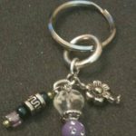 A key chain with various charms and beads.