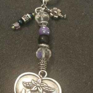 A silver key chain with beads and charms.