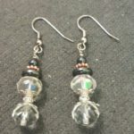 A pair of earrings with black and white beads.