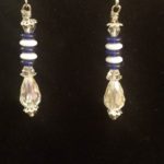 A pair of earrings with blue and white beads.