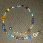 A bracelet with beads and charms on it.