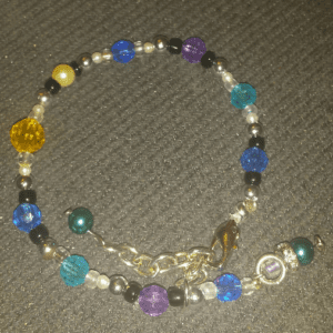 A bracelet with beads and charms on it.