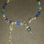 A bracelet with beads and charms on it.