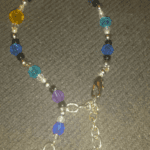 A necklace with blue, purple and yellow beads.