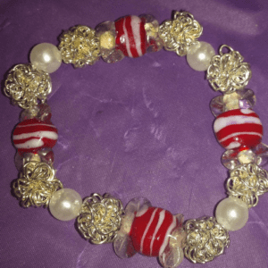 A bracelet with red and white beads on it