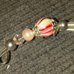 A key chain with beads and silver metal.