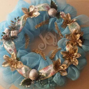 A wreath made of blue tulle and gold flowers.