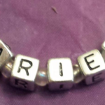 A purple cloth with the word " friend " written on it.